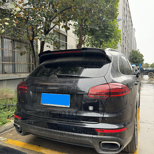 Black Porsche Cayenne with roof-mounted cargo bag spoiler, 2015-2017 style