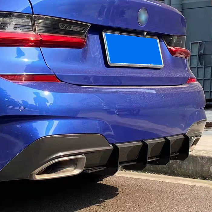 Glossy black blade diffuser for BMW 3-series G20 M-Pakke installed on blue car rear bumper