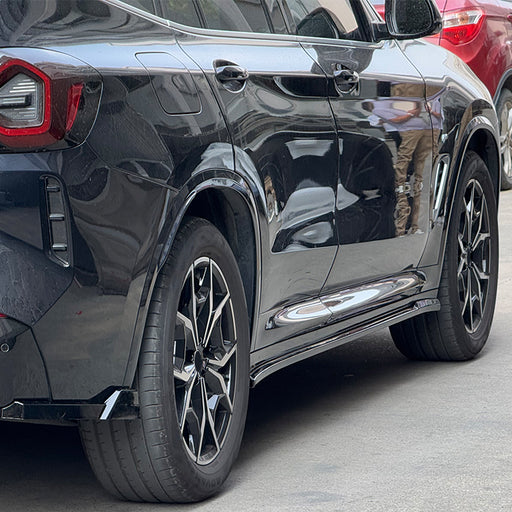 Black BMW X3 G01 side skirts with polished chrome rocker panel trim detail