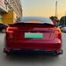 Rear view of red Tesla Model 3 with black rear diffuser and side splitter, 2023+ model