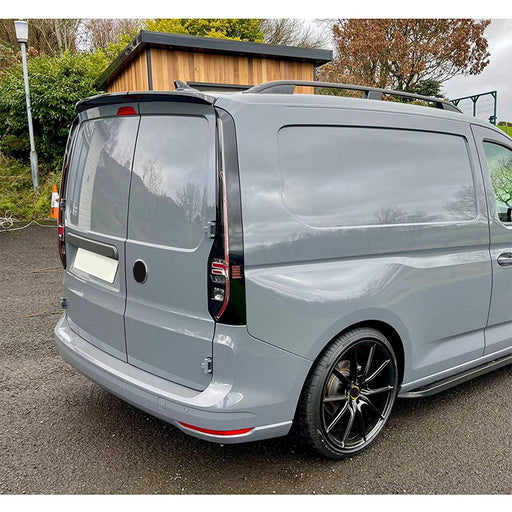 Black rear spoiler for Volkswagen Caddy 2021+ with rear doors, mounted on silver van