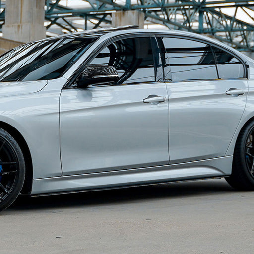 Gloss black side skirts BMW F30/F35 2017-2023 installed on white sedan