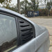 BMW E90 Bagrude Lameller Cover in black with horizontal louvers installed on rear quarter window