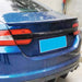 Black blank rear spoiler for Jaguar XF 2013-2015 mounted on blue sedan